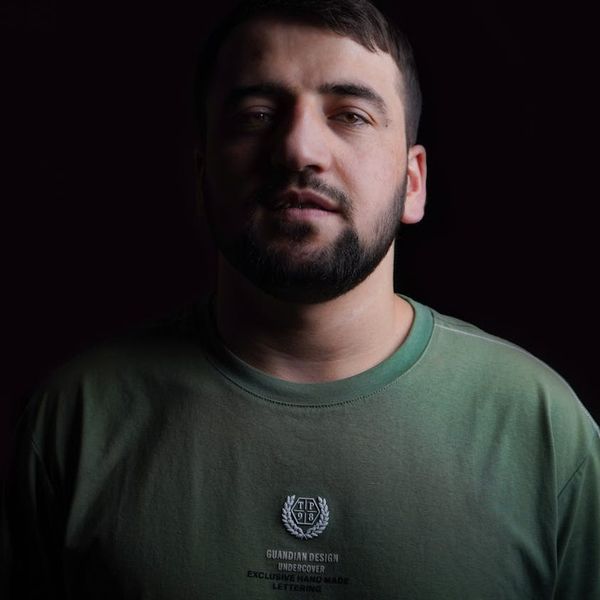 Silhouette of a man in a meditative pose against a dark background with abstract light lines.